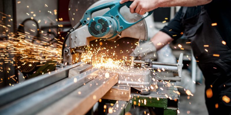 Man,,Worker,Using,A,Sliding,Compound,Mitre,Saw,With,Circular