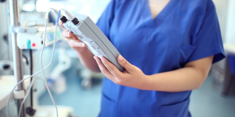 Female,Doctor,Adjust,Electronic,Medical,Device.